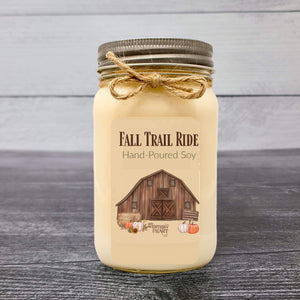 fall trail ride candle in mason jar with old barn on label