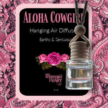 Aloha Cowgirl hanging air diffuser with pink floral design on a pink paisley background