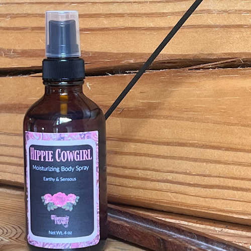 Hippie Cowgirl moisturizing body spray bottle on a wooden surface