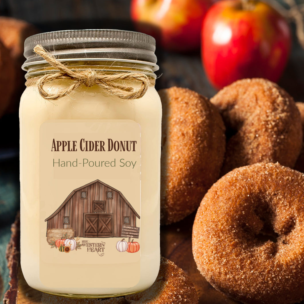 apple cider donut candle in mason jar in front of apple cider donuts