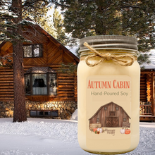 Autumn Cabin candle in front of log cabin mason jar candle