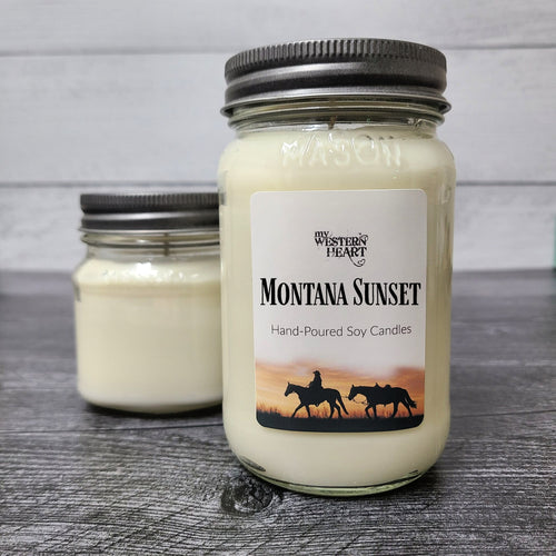 Montana Sunset Candle has cowgirl with horses and sunset