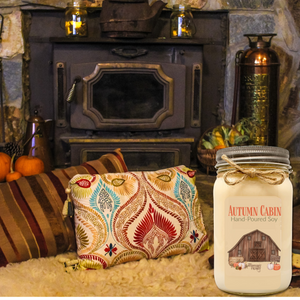Autumn Cabin hand-poured soy candle in room with fireplace